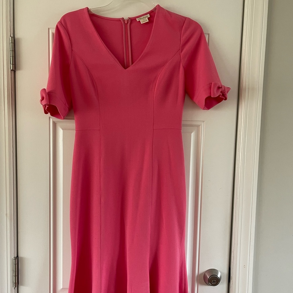 MIDI length dress that flares out a bit with cute sleeve bow detail.